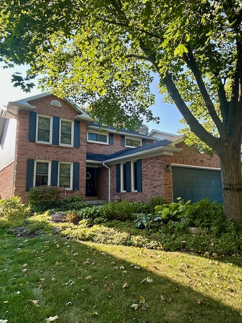 134 Watsons Lane, Coote's Paradise, Dundas home exterior. Brick house with blue shutters and a green lawn.