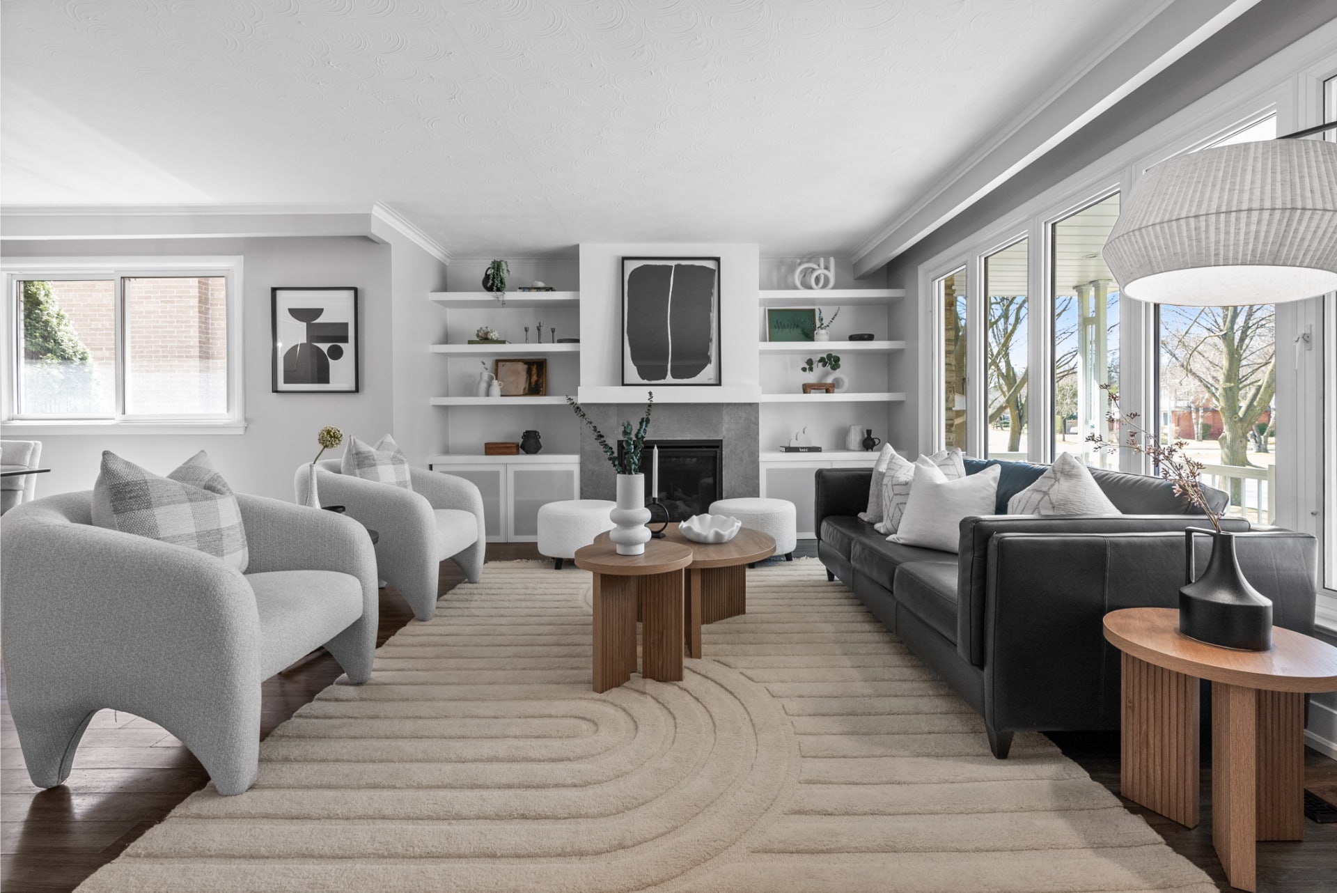 Staged living room showcasing home decor, modern furniture, built-in shelves, and stylish interior design. Real estate staging.